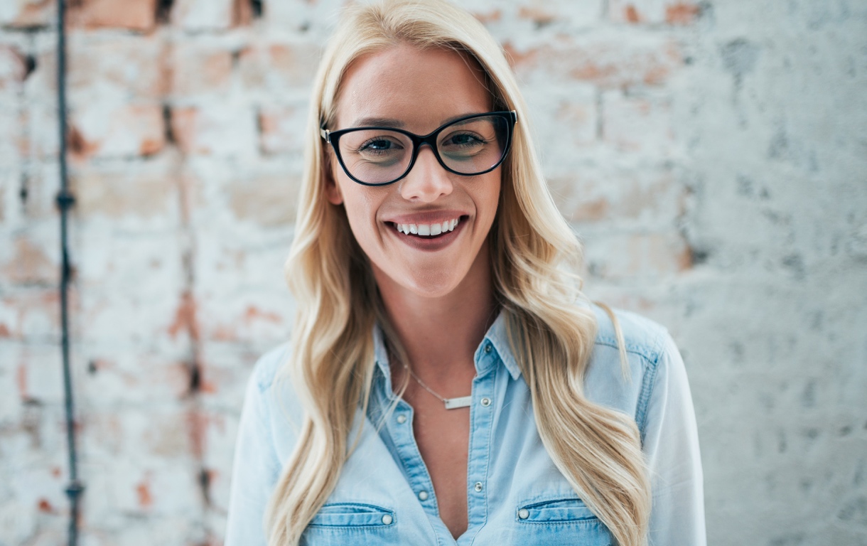 Woman with long blond hair at optical shop