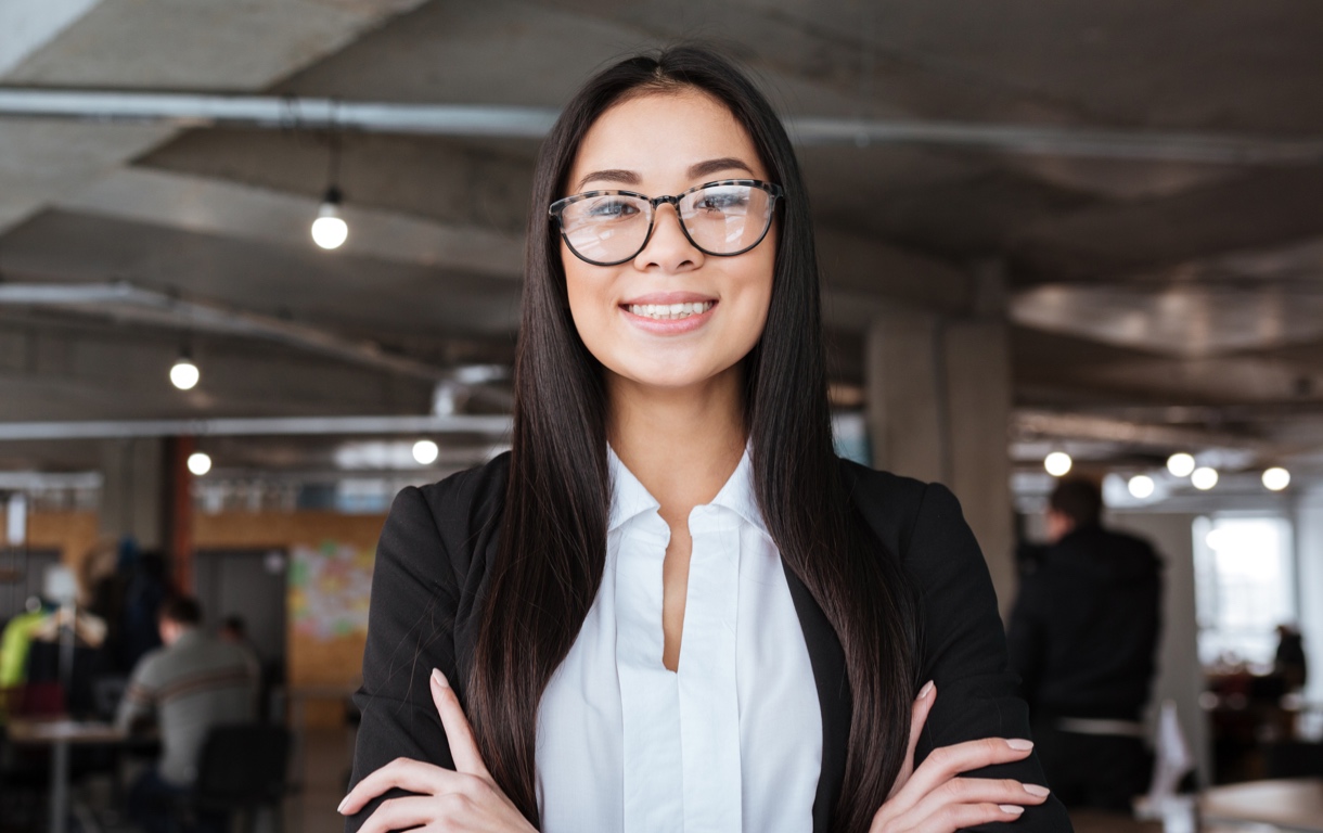 Young woman wearing glasses with arms crossed